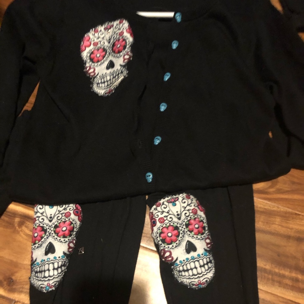 Black skull cartigden with black stretch pants .